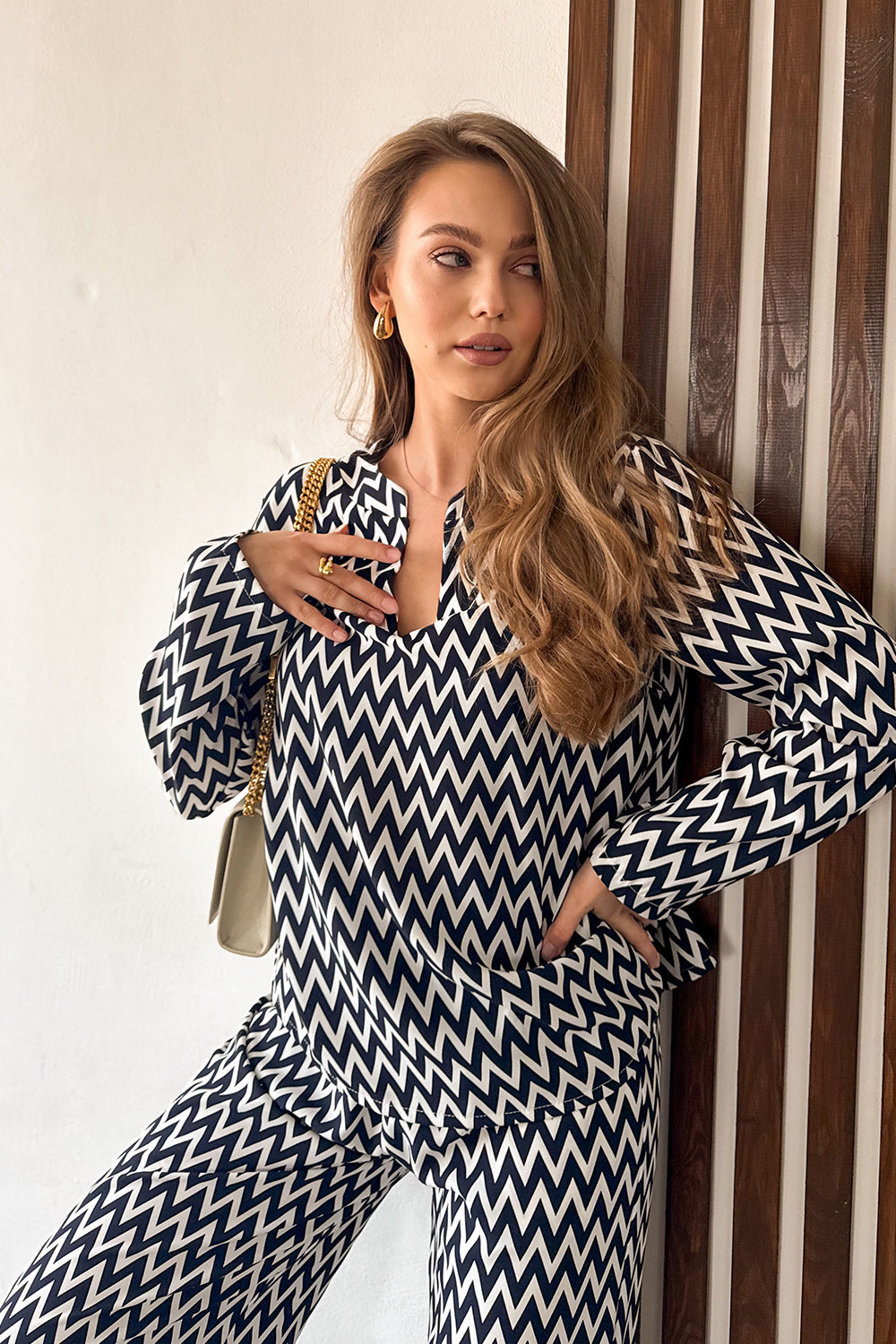 Blue trouser suit with slits and a shaped neckline