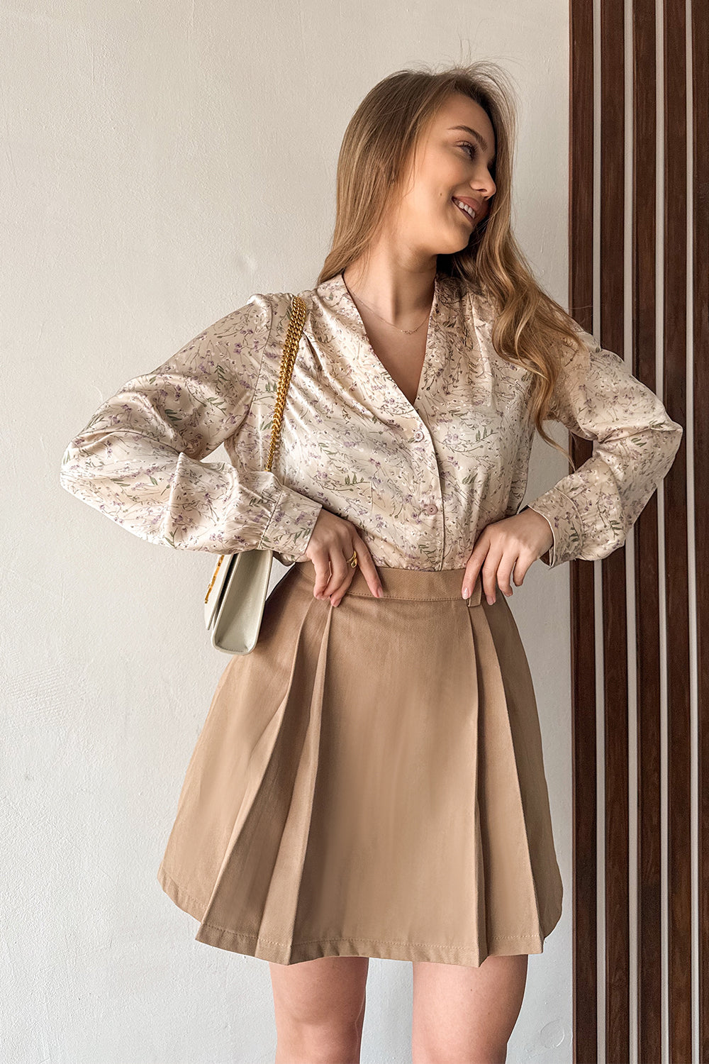 Beige A-line skirt with elegant pleats at the front