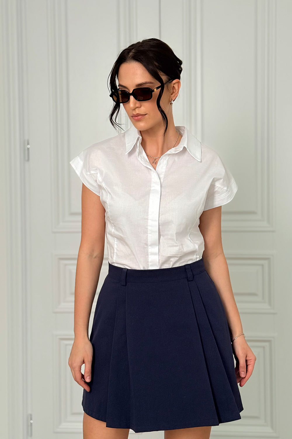 Blue A-line skirt with elegant pleats at the front