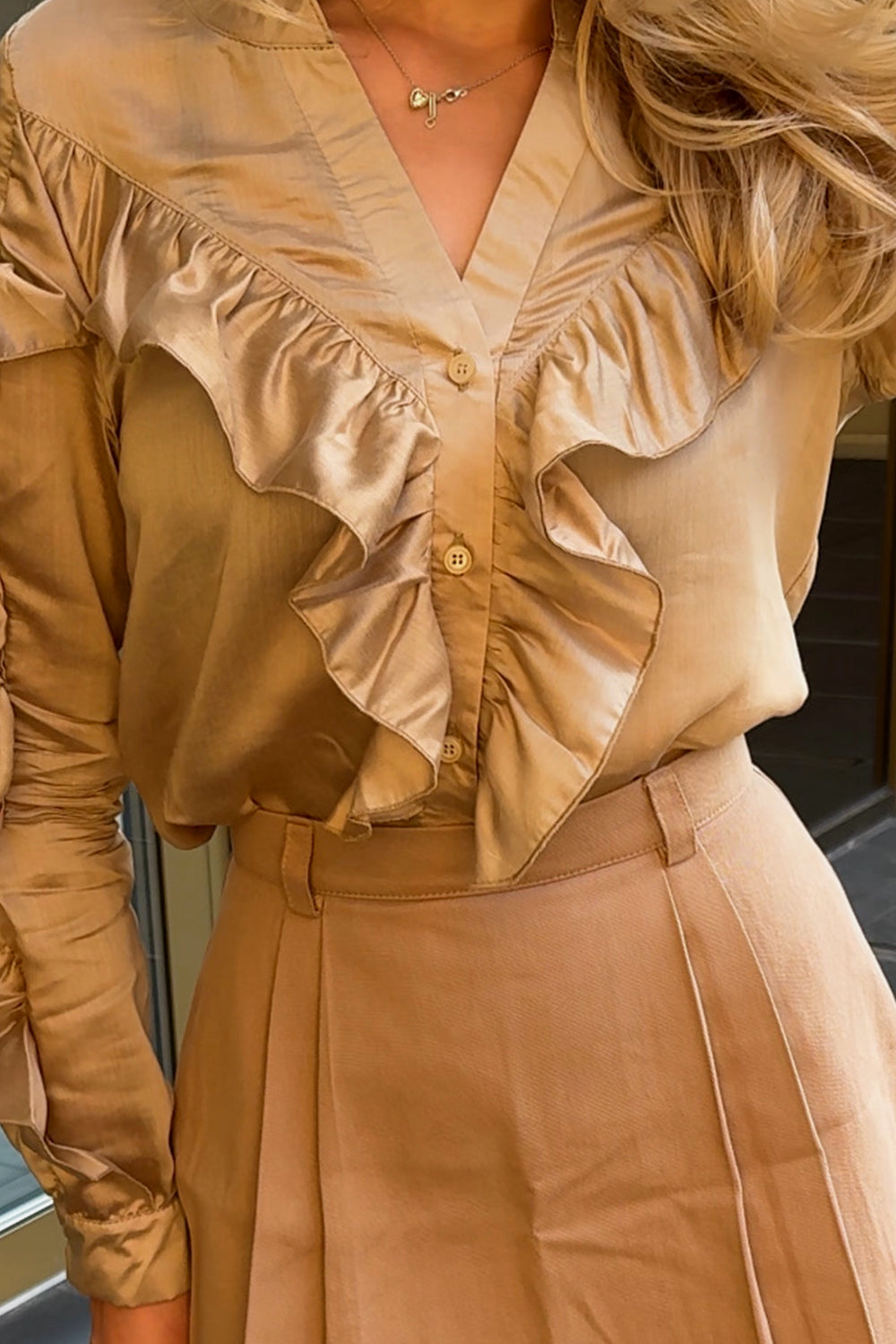 Stylish gold blouse with frills